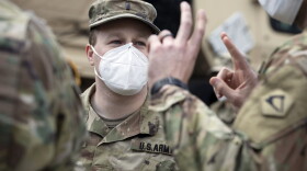 A Massachusetts National Guard soldier wears a protective mask while on duty at a food distribution site outside Chelsea City Hall in April 2020. (Michael Dwyer/AP file photo)