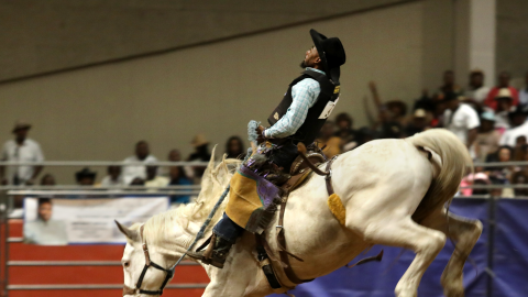 Marcus Verser participates in a bronc riding event during the Texas Black Invitational Rodeo at the Fair Park Colluseum in Dallas, TX, on Jul 29, 2023.