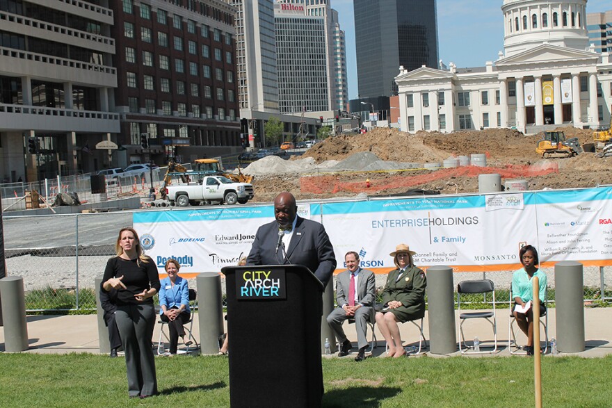 CityArchRiver board member and Boys and Girls Club of Greater St. Louis President Flint Fowler speaks during the groundbreaking Wednesday, April 29, 2015. Behind him construction of the park over the highway connecting the courthouse to the Arch grounds i