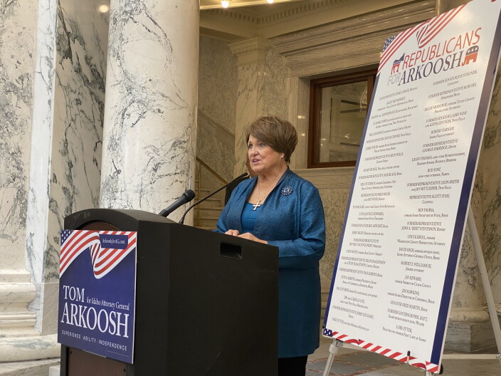 Patti Anne Lodge at a podium endorsing Democrat Tom Arkoosh