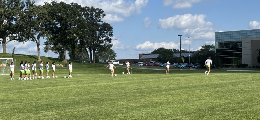 Members of the Western Iowa Tech Community College women's team warms up for the first ever game on the new soccer field that has been added at the Sioux City campus, as of August 19, 2025. (Bret Hayworth, Siouxland Public Media News)