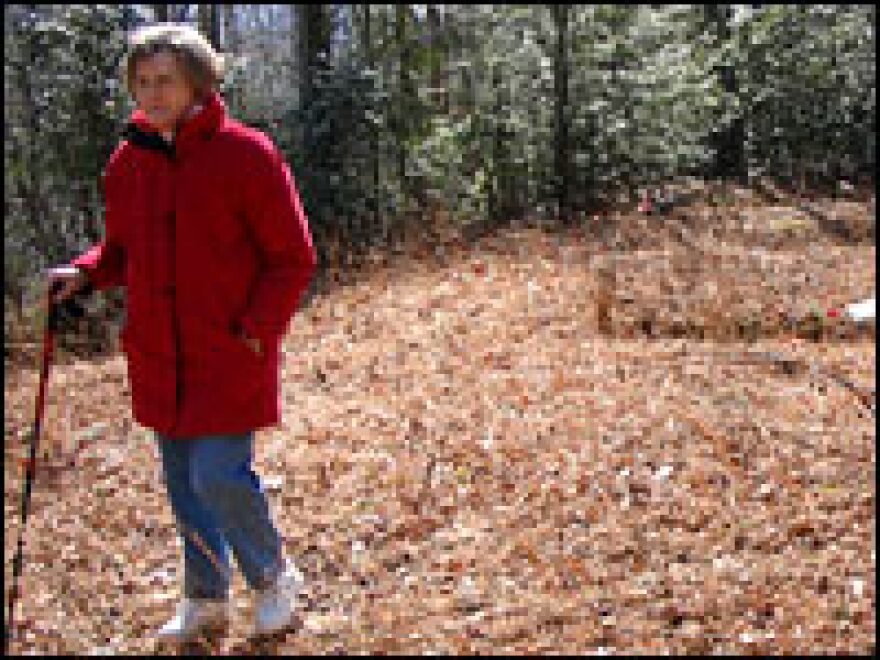 Peggy Medford explores an old graveyard on land her family once owned. In the 1940s, the federal government took her family's property, which now is part of the Great Smoky Mountains National Park.