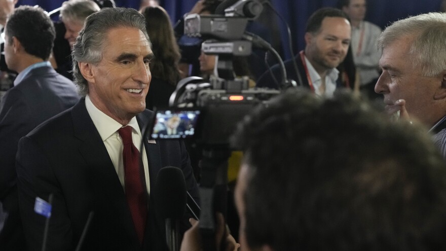 North Dakota Gov. Doug Burgum speaks to reporters in the spin room after a Republican presidential primary debate on Aug. 23.