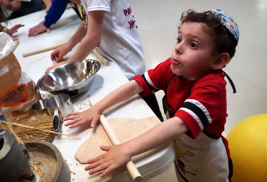 Young kids learn how to make matzo during a Passover lesson at Keneseth Israel synagogue in Louisville on April 13, 2022.