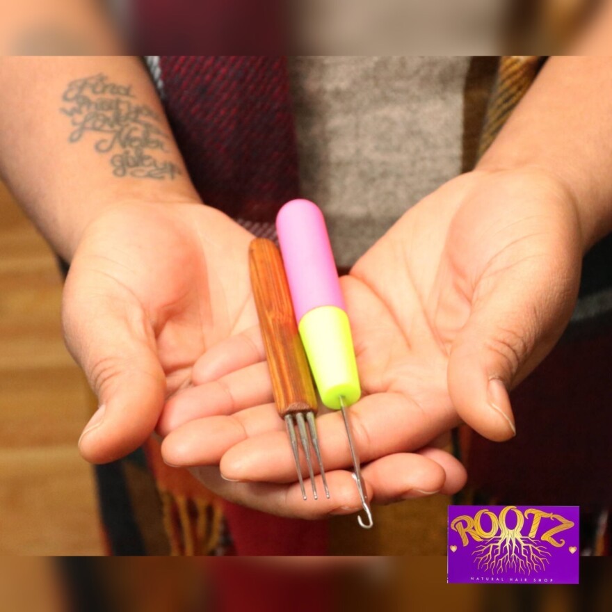 Pictured here is a crochet hook and crochet needles used for loc hair services and crochet installs at Roots Natural Hair Shop in Manchester. These are some of the many services the salon offers for natural hair.