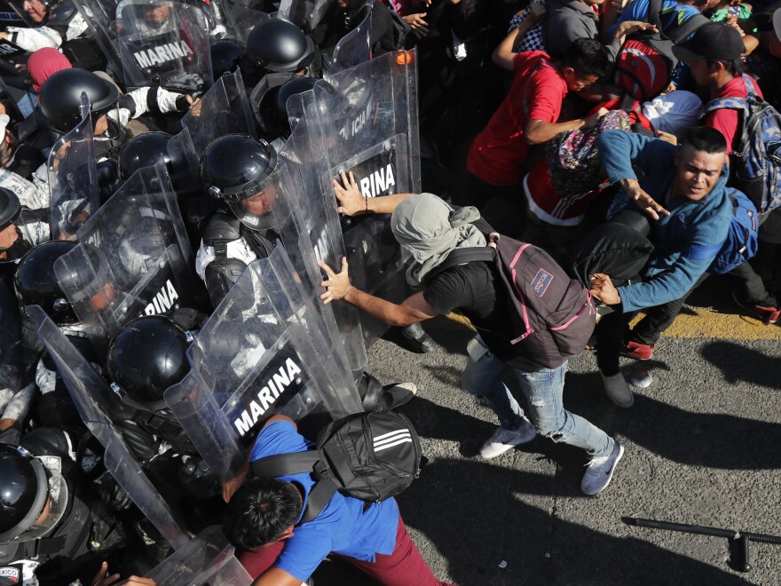 Migrants charge on Mexican National Guard troops at the border crossing between Guatemala and Mexico, near Ciudad Hidalgo, Mexico and Tecun Uman, Guatemala, on Jan. 18.