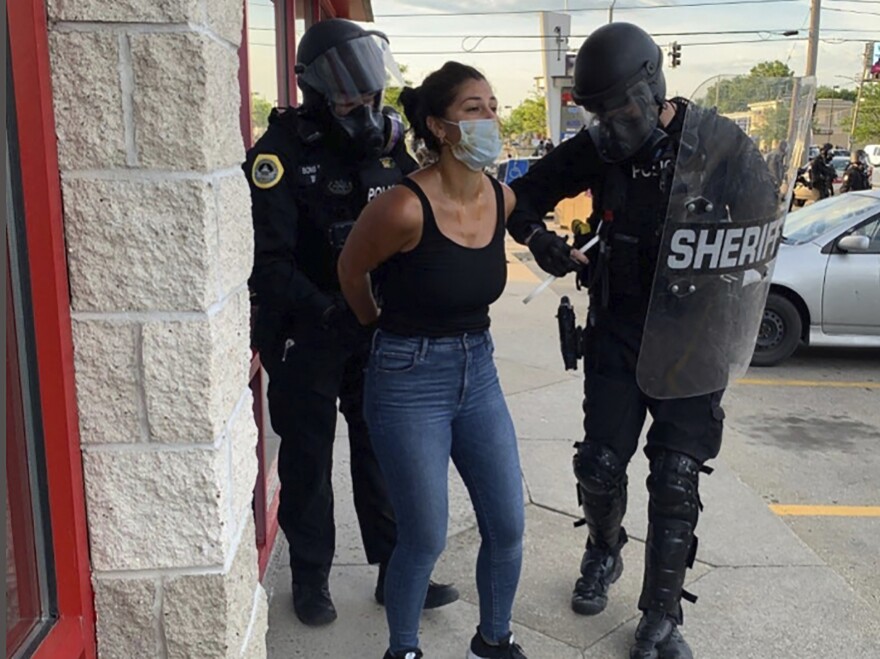 Police officers are shown arresting Des Moines Register reporter Andrea Sahouri after a Black Lives Matter protest she was covering on May 31, 2020, in Des Moines, Iowa. Sahouri went on trial Monday on charges of failing to disperse and interfering with official acts.