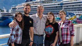 A group of smiling people pose aboard a retired Alaska Marine Highway ferry.