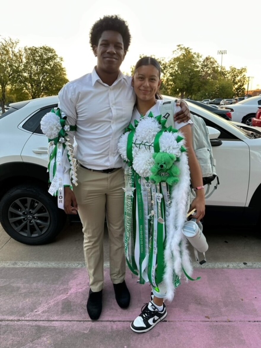  Bilyndera Walker’s son standing next to his girlfriend wearing their homecoming mum and garter. 