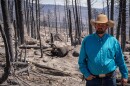 Trevor Barnson stands in front of one of his dead cows, June 30, 2026. He estimates that he lost around 30 of his cattle and two-thirds of his grazing land to the Cottonwood Fire.