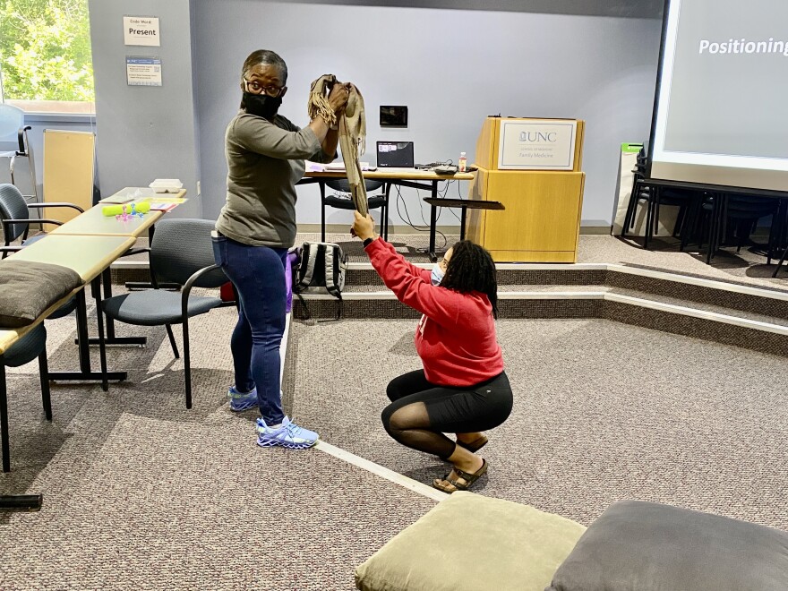 Certified birth Dona Instructor Tonya Daniel (standing) coaches ABDBM doula-in-training Oona-Ife Olaiya Wright during one of the organizations Doula training earlier this year.