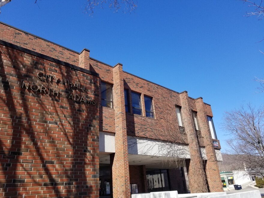 A brutalist brick building sits under a blue sky.