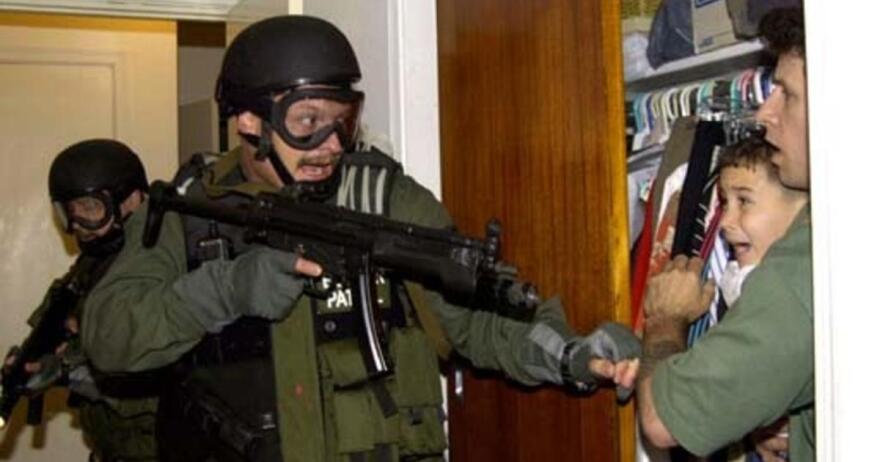 Federal agents seizing 6-year-old Elian Gonzalez from the home of his Miami relatives in 2000 to reunite him with his Cuban father.