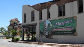 In downtown Mayfield, a sign commemorating the historic locations echoes the courthouse spire that stood before December's tornado tore it down.