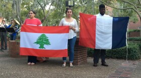 Students hold the flags of Lebanon and France during a vigil on Nov. 16, in remembrance of those who lost their lives in the recent terrorist attacks. Lebanese students expressed concerns that Facebook only had safety notifications for those who had relatives and friends in Paris and not in Beirut and other places where attacks occurred. Photo by Ahmad Krecht, Vice President of the Lebanese American Society.