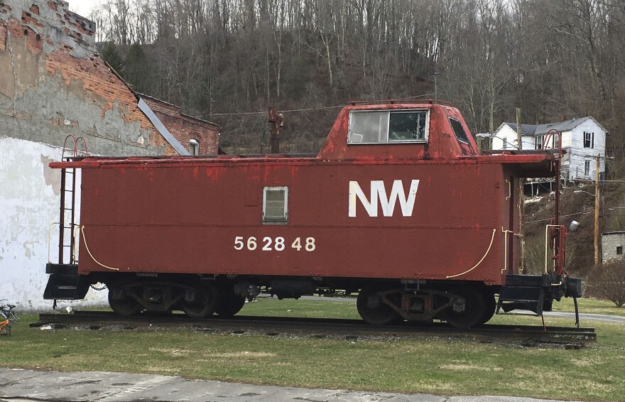 This Feb. 15, 2017 photo shows an old Norfolk and Western Railway caboose at the end of a rundown commercial block in Matoaka, W.V., where coal trains used to run several times a day and at night.