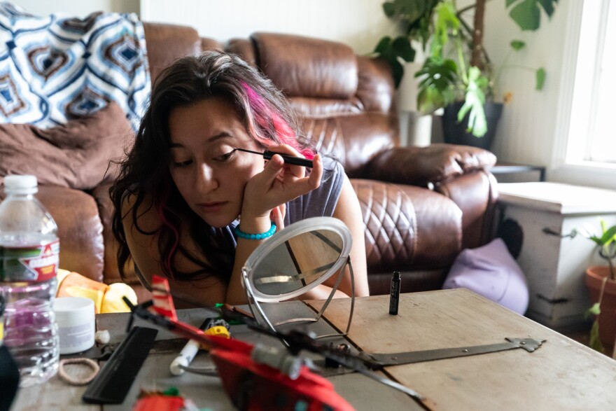 Amanda Phillips puts on eyeliner on Oct. 14, 2022, at her home in Austin. Phillips identifies as bisexual and has been dating more women since the overturning of Roe v. Wade. Michael Minasi / KUT News