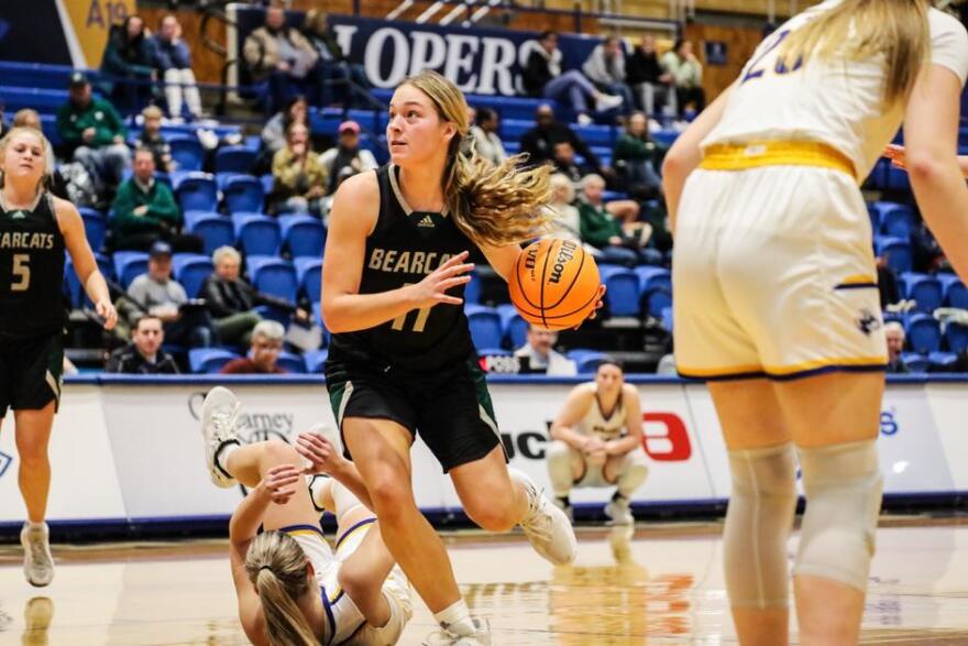 Action shot of Ella Moody vs UNK basketball