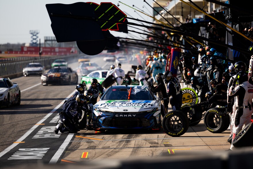 John Hunter Nemechek's pit crew changes his tires and refuels his car.