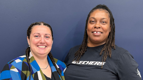 photo of two women smiling next to eachother 