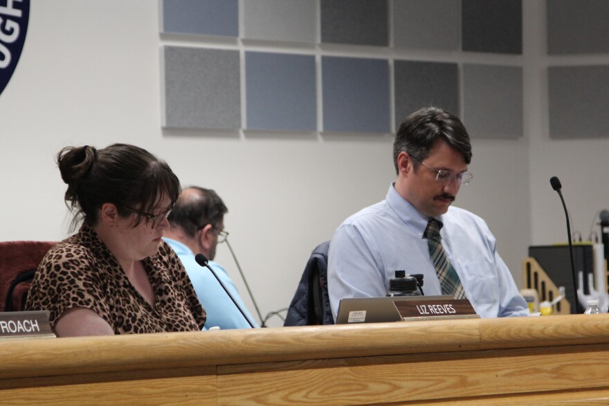 Fairbanks North Star Borough Assembly members Liz Reeves, left, and Scott Crass, right, listen to public testimony about renaming Pioneer Park during a meeting that began April 23, 2026, which ran into the following day. Reeves and Crass cosponsored an ordinance to revive the park's former name, "Alaskaland." It passed April 24, 2026.