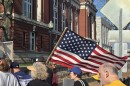 A protestor waves a flag in front of Missouri's Supreme Court on Tuesday, March 10. Protestors were opposing the state's redistricted map, which was being ruled on by the Supreme Court Justices.