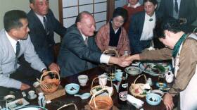  Filmmaker Herbert Sussan at a dinner in Japan with hibakusha, survivors of the atomic attacks. (Courtesy of Leslie Sussan)