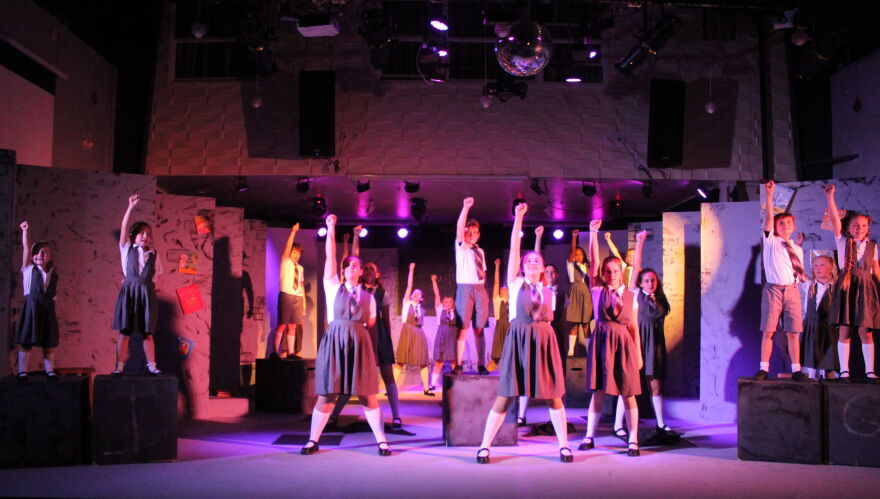 Bruce and his fellow students perform 'Revolting Children' in Matilda.