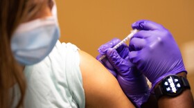 A person gets vaccinated against COVID-19 at a walk-in clinic in East Austin in March.