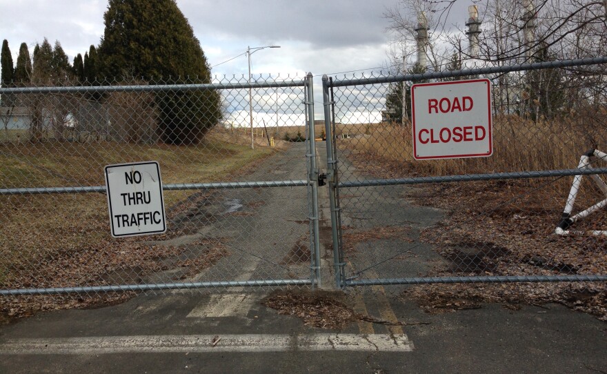 A fence leading to a PCB toxic waste dump in a Pittsfield, Massachusetts, neighborhood, adjacent to an elementary school athletic field.