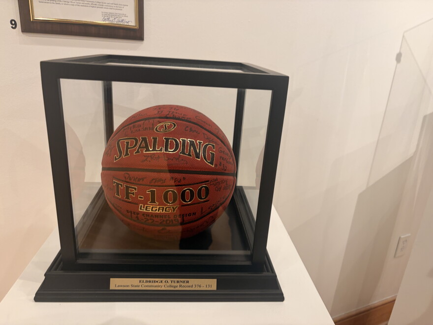 A basketball that reads "Spalding TF-1000" in a glass case