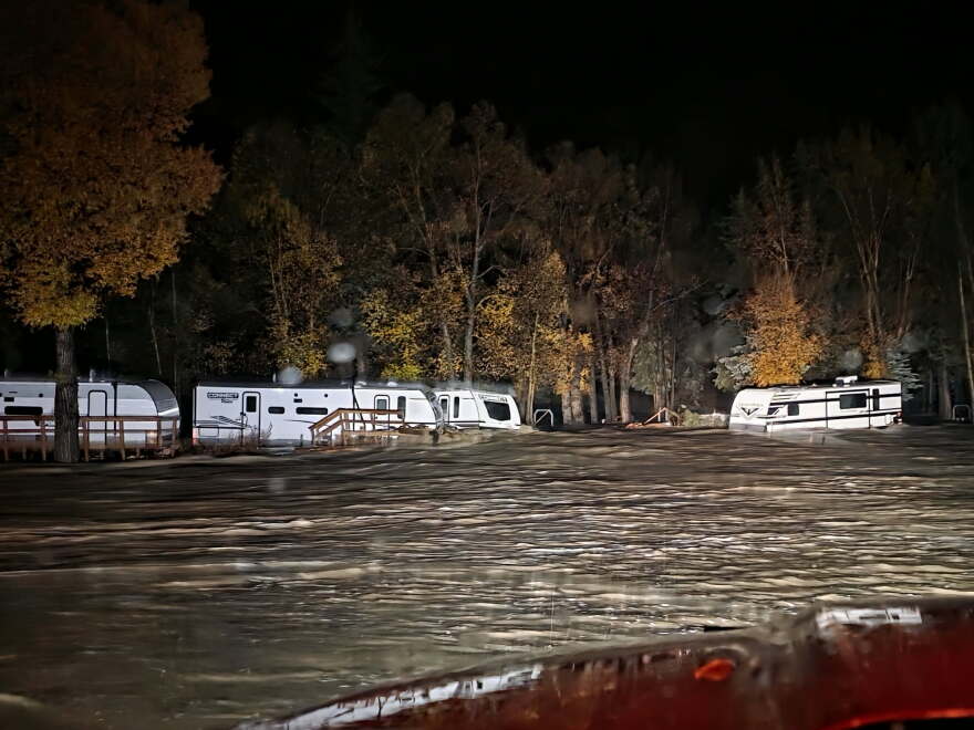Floodwaters surround trailers at the Fun Valley Family Resort campground and RV part in South Fork, Colo., early Friday, Oct. 23, 2026.