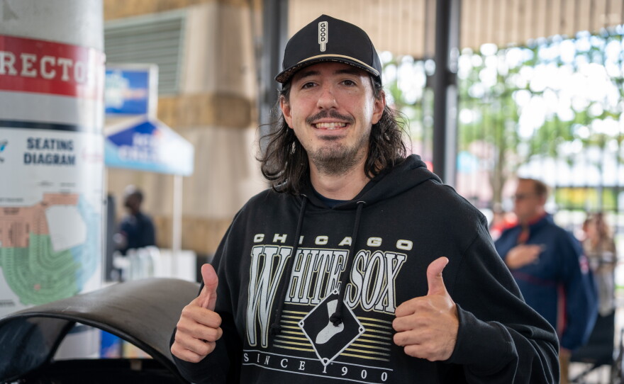 Man in White Sox Shirt gives thumbs up.