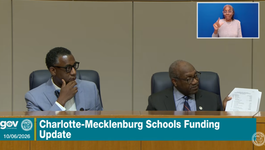 Mecklenburg Commissioners Mark Jerrell (left) and Arthur Griffin discuss the county's role in asking questions of CMS