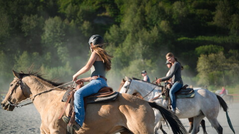 Ailey Hiner (left) rides with Naamah North (right) and others during a drill team practice on Sep. 2