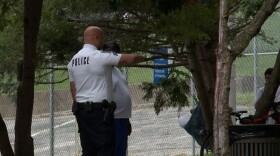 An officer speaking with someone in Seminary Park.