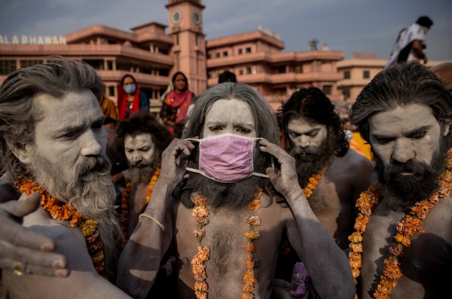 A Naga Sadhu, or Hindu holy man, wears a mask before the procession for taking a dip in the Ganges River during Shahi Snan at "Kumbh Mela," or the Pitcher Festival, amid the pandemic in Haridwar, India, on April 12, 2021.
