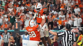Miami running back Javian Mallory (21) celebrates with offensive lineman Ben Congdon (58) after scoring a touchdown during the second half of an NCAA college football game against Florida State, Saturday, Oct. 17, 2026, in Miami Gardens, Fla.