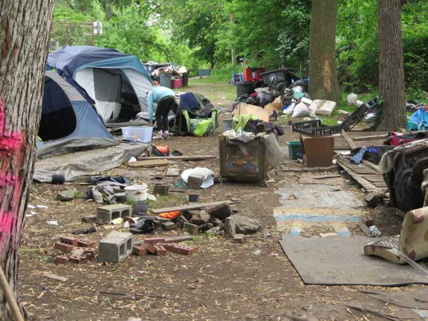 Stormy attempts to clean her latest campsite before leaving. [Rick Jackson / ideastream]