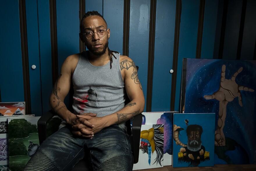 Joshua Williams, paints in his home art studio in Kansas City, Missouri. He’s worked as a janitor and, after two months of being furloughed, he is worried about being called back to work. 