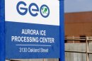  A blue sign that says "Aurora ICE Processing Center"