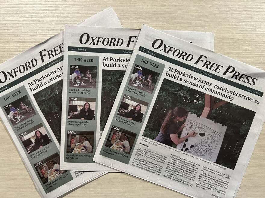 3 newspapers on a table
