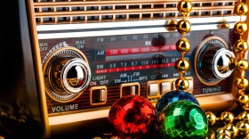 Vintage radio draped with holiday ornaments