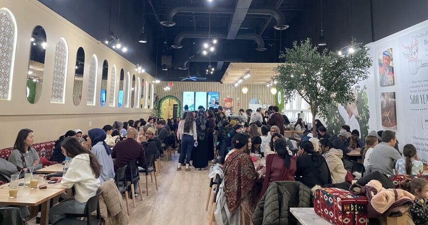 A bustling crowd at Qamaria Yemeni Coffee Company in Latham