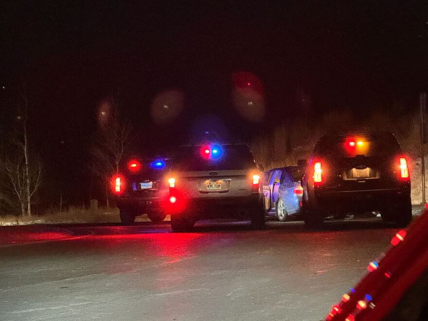 Picture of unmarked law enforcement surrounding vehicle.