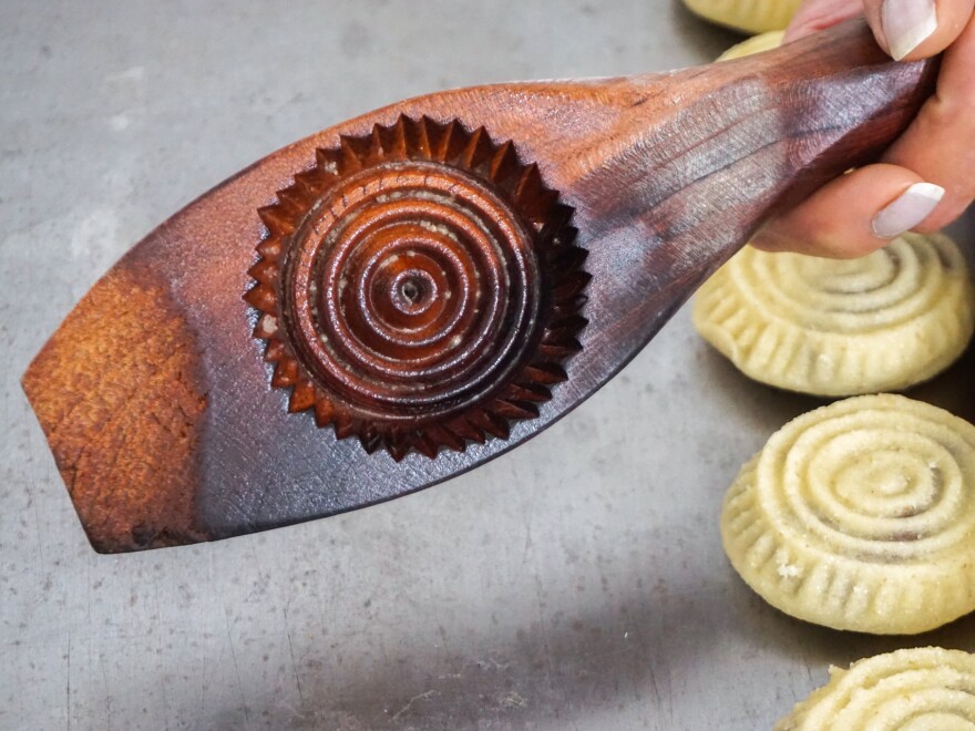 Traditionally carved wooden molds are used to give shape and form to the <em>maamoul </em>cookies.