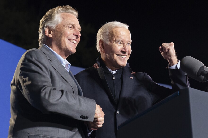 President Joe Biden, right, reacts after speaking at a rally for Democratic gubernatorial candidate, former Virginia Gov. Terry McAuliffe on Tuesday, Oct. 26 in Arlington, Va. McAuliffe will face Republican Glenn Youngkin in the election on Nov. 2.