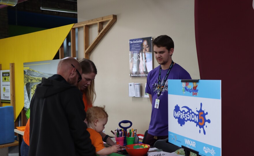 Family creating an art project together with the help of Impression 5