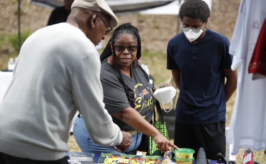 Festival shops for clothing during the 2022 Publix Tampa Bay Collard Festival in St. Petersburg, Florida, on Saturday, February 19, 2022. Photo by Octavio Jones for WUSF