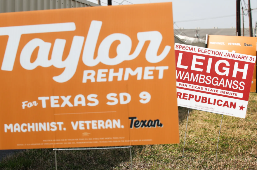 Campaign signs for Texas Senate District 9 candidates Democrat Taylor Rehmet and Republican Leigh Wambsganss sit outside the Tarrant County Elections Administration on Jan. 22 in Fort Worth.